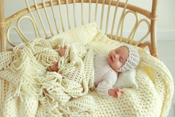 Newborn photography Monsey NY – sleeping newborn in rattan chair